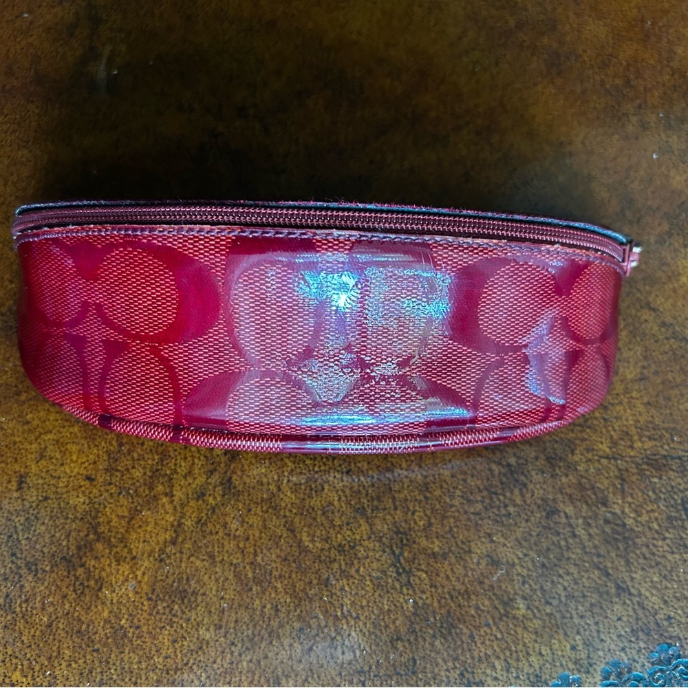 Coach Signature Red Eyeglass Pouch with zipper closure.